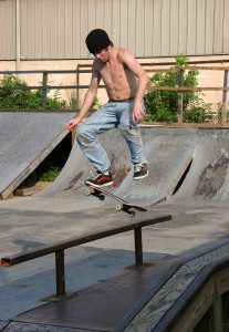 Skateboarder Landing on Rail