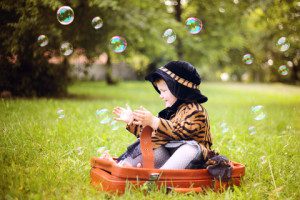 http://www.dreamstime.com/stock-image-little-cute-girl-hat-cloak-sitting-suitcase-image29645901
